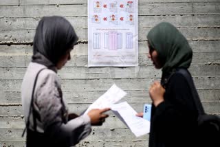 Women read instructions to voters ahead of the upcoming municipal elections in Deir el-Balah in the central Gaza Strip on April 21, 2026