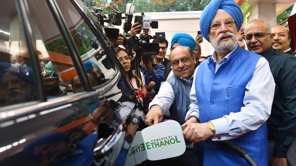 Union Minister for Petroleum and Natural Gas Hardeep Singh Puri fills E85 fuel in a car during the during the launch of E85 fuel on World Environment Day on June 5