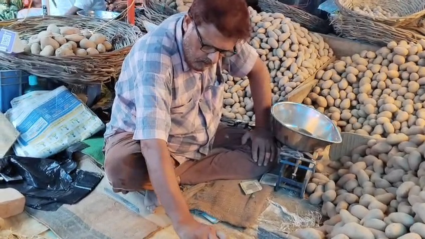 Altaf's father sitting at the potato shop.