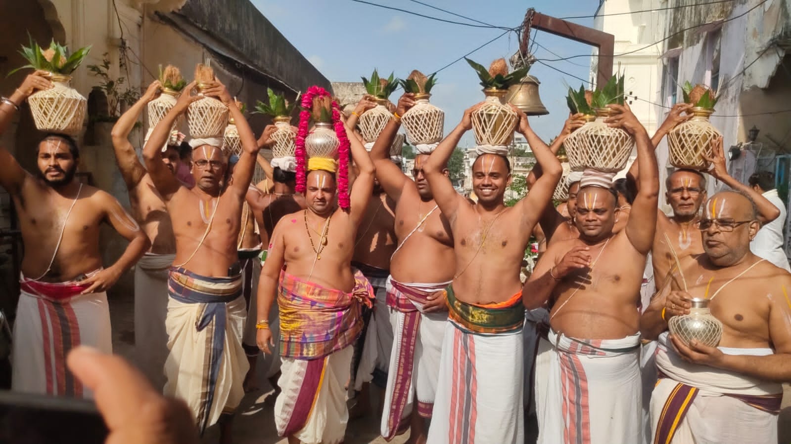 Priests carry away water filled from the lake