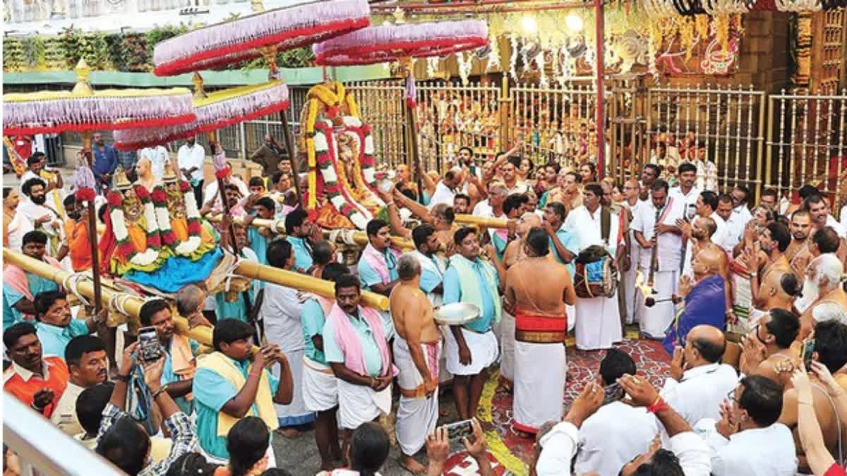 Lord Malayappa Swamy, accompanied by Sridevi and Bhudevi, being taken in a procession along the Mada Streets in Tirumala