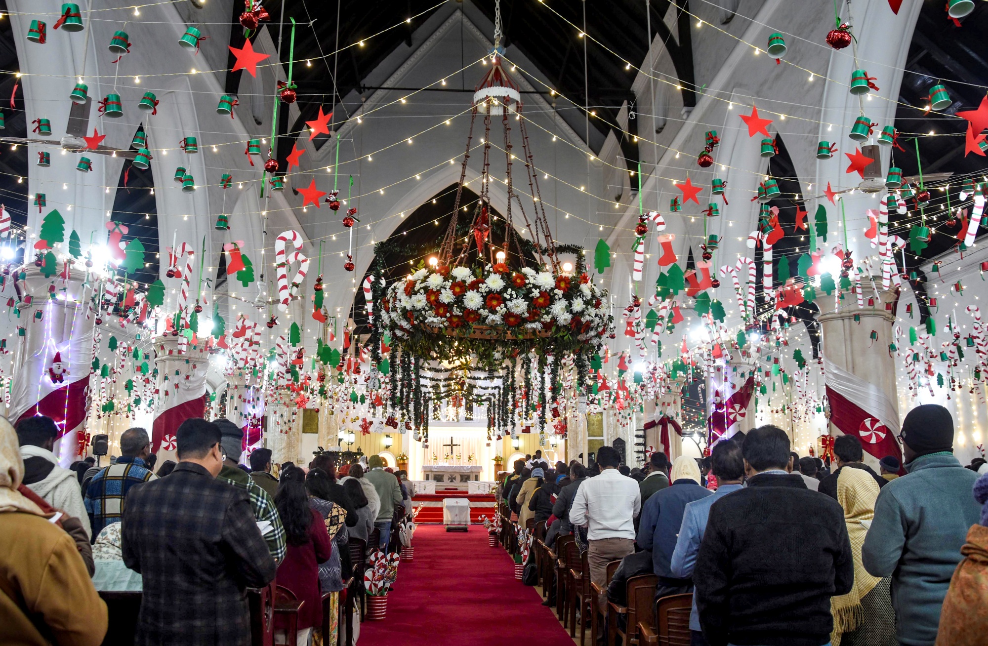 People gather for a midnight mass on the eve of the Christmas festival