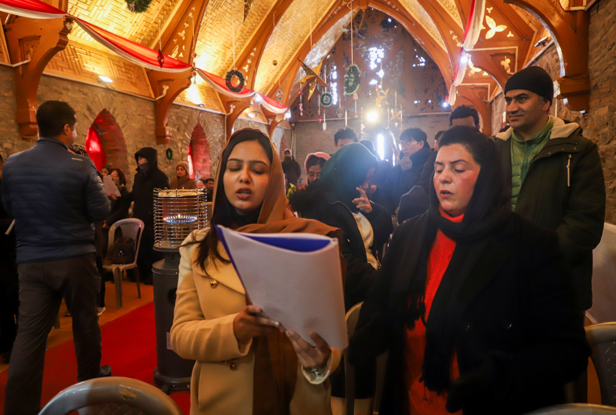 People offer prayers at a church on the eve of the Christmas festival, in Gulmarg, Baramulla district, Jammu and Kashmir, Wednesday, Dec. 24, 2025