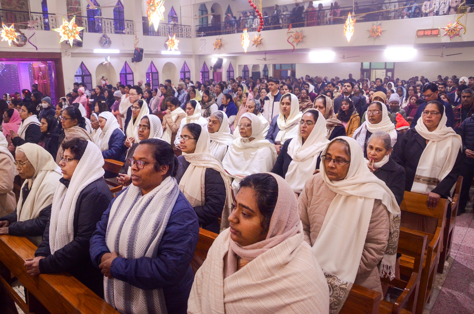 People offer prayers at a midnight staff on the eve of the Christmas festival, at the St. Francis Xavier's Church, in Kanpur, Uttar Pradesh, Wednesday, Dec. 24, 2025
