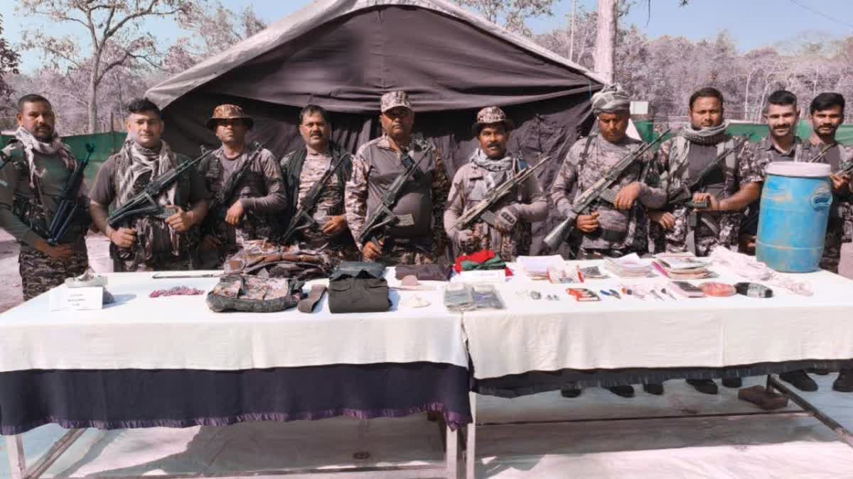 Security personnel with recovered weapons