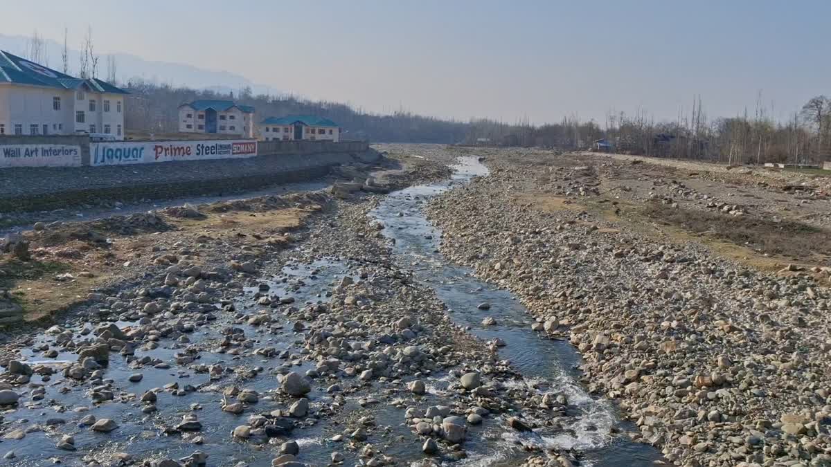 A view of receding water flow in a river in south Kashmir