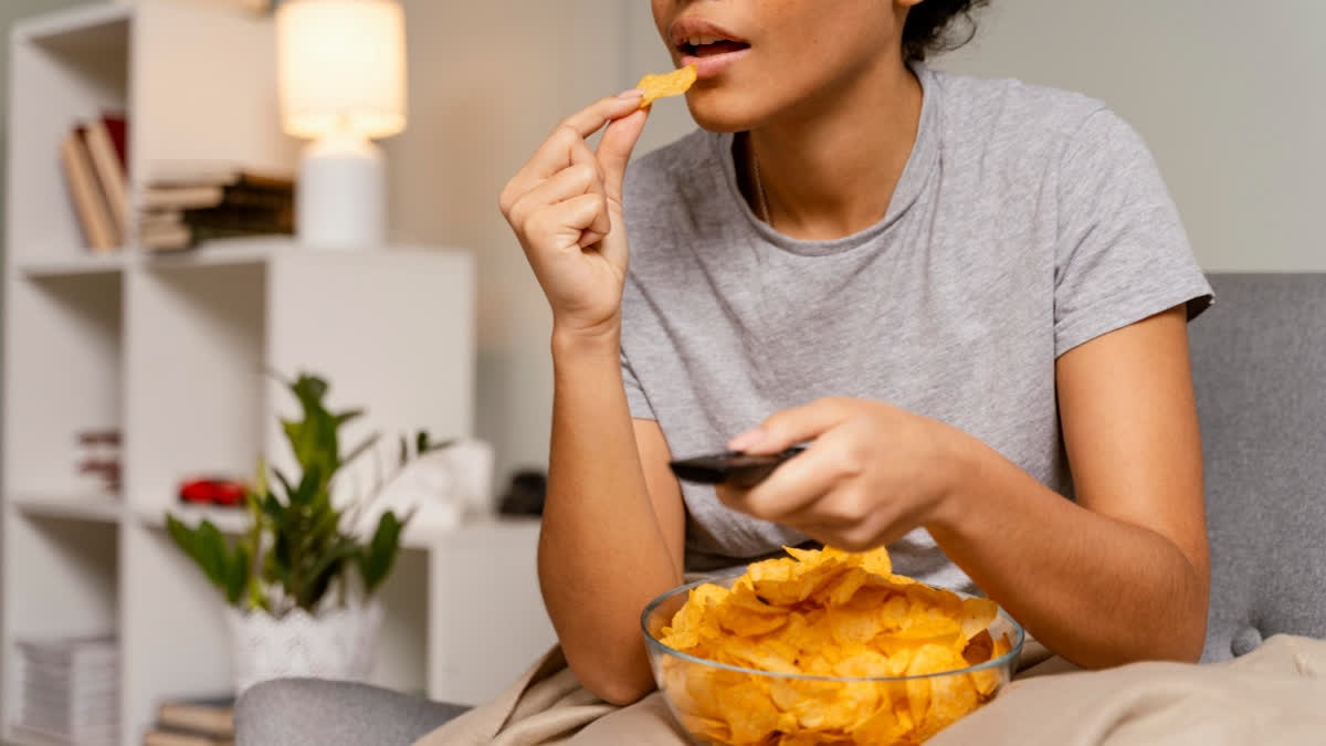Teenager eating chips