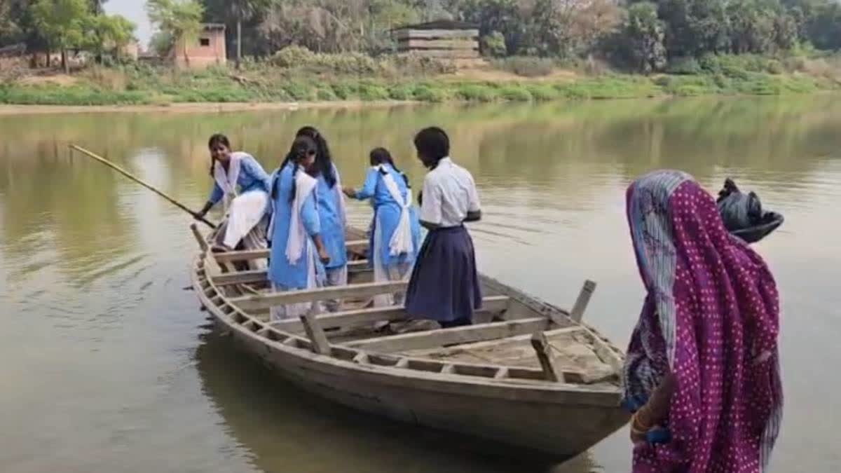 Children row a boat to ferry students in Sakuchidih village.