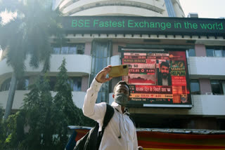 A man clicks a selfie in front of digital screen outside the Bombay Stock Exchange (BSE) in Mumbai on Feb 24, 2022.