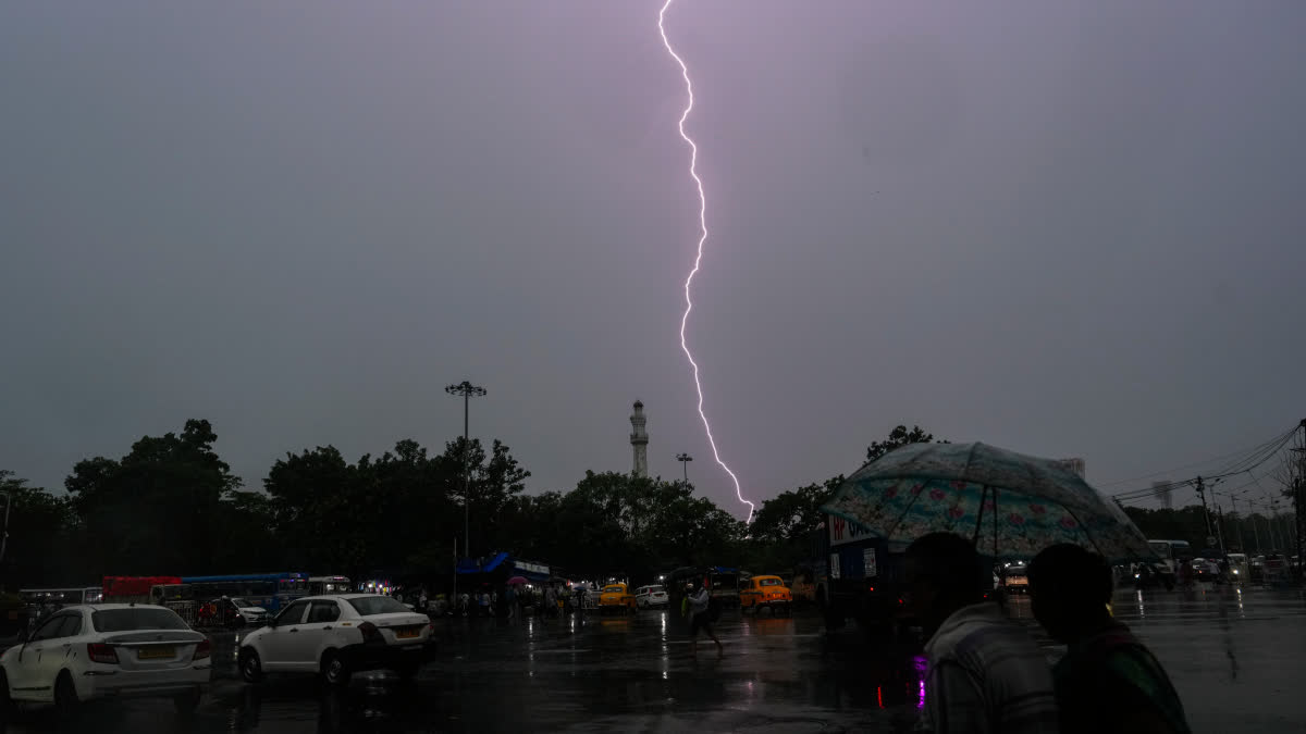 Lightning streaks across the sky during rain over the city in Kolkata.