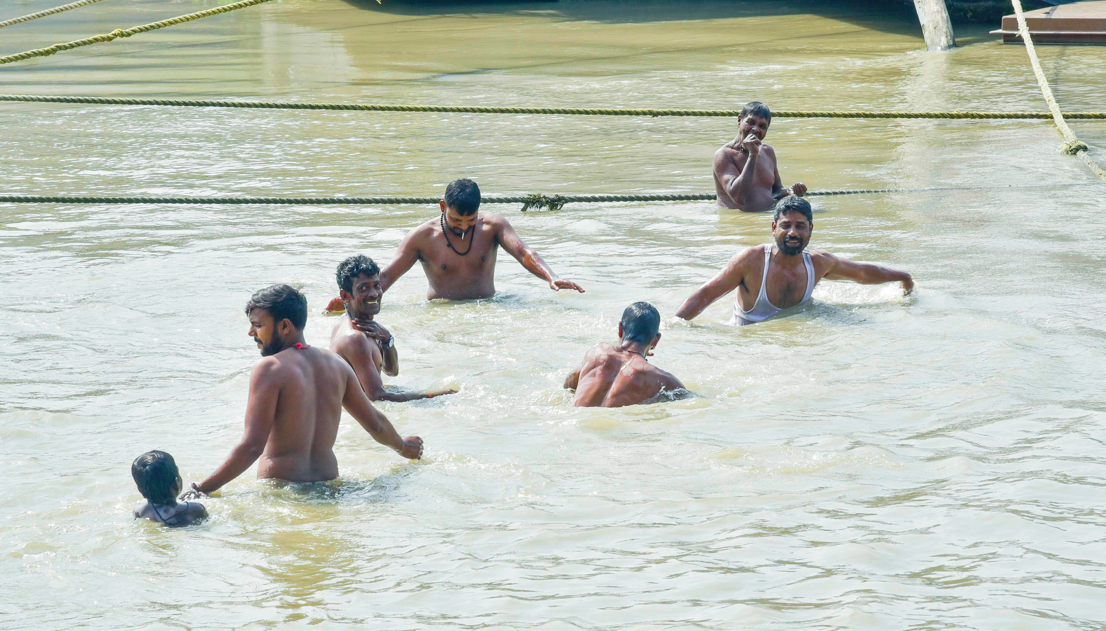 People enjoy a refreshing dip in the Brahmaputra River as the mercury continues to soar in Guwahati.