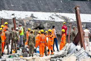 NDRF and security personnel conduct a search and rescue operation a day after an under-construction warehouse collapsed in Taratola, Kolkata, on Thursday, June 25, 2026.