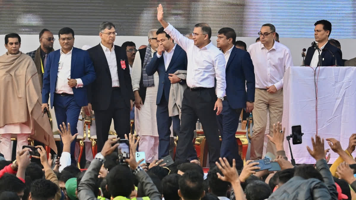 Tarique Rahman (4R), son of former prime minister Khaleda Zia and Bangladesh Nationalist Party (BNP)'s acting chairman waves to supporters during a rally after his arrival in Dhaka on December 25, 2025.