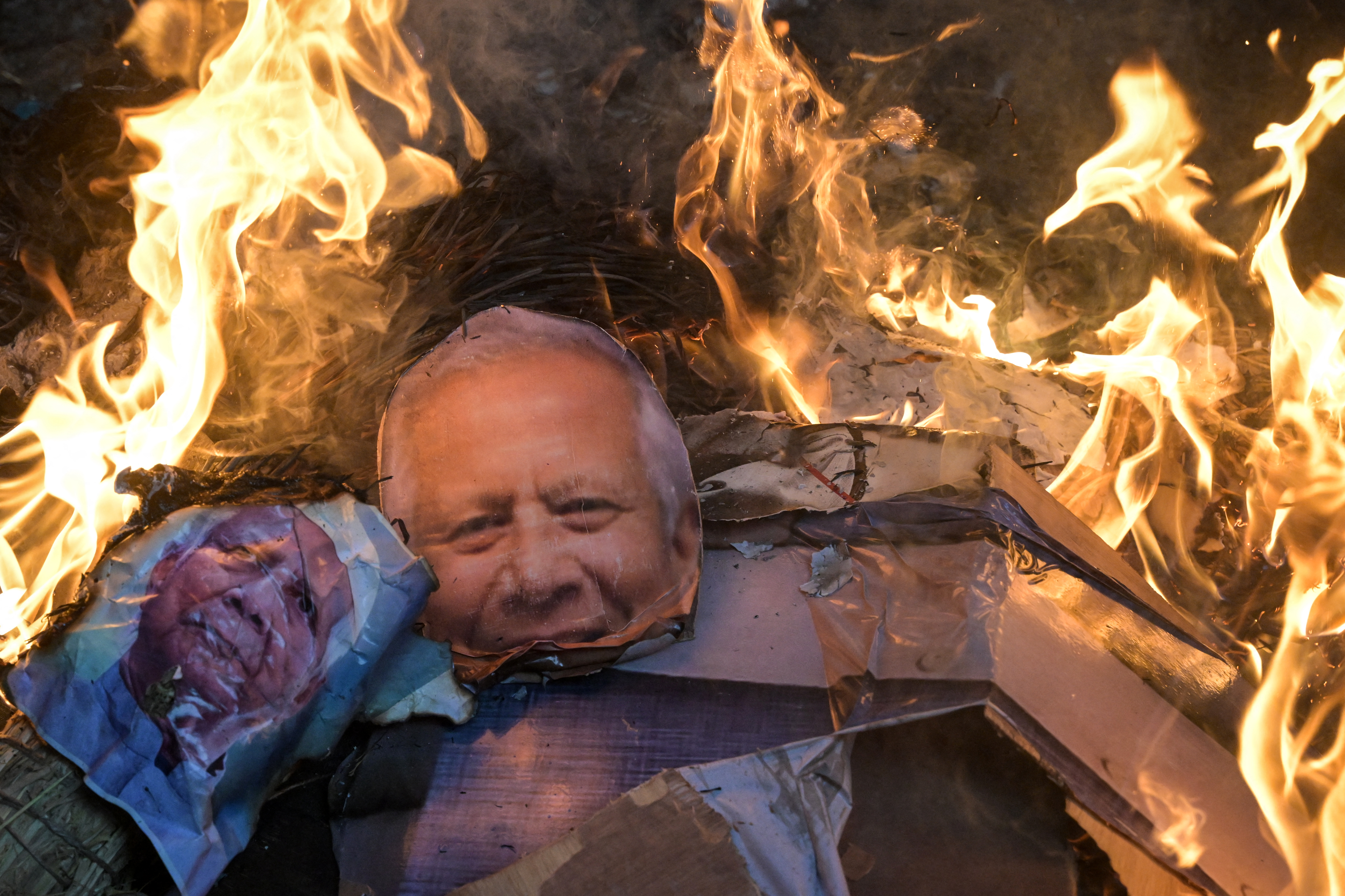 Bharatiya Janata Party (BJP) and religious activists burn posters of Muhammad Yunus, Chief Adviser of Bangladesh's interim government during a protest near the Deputy High Commission of Bangladesh office in Kolkata on December 22, 2025.