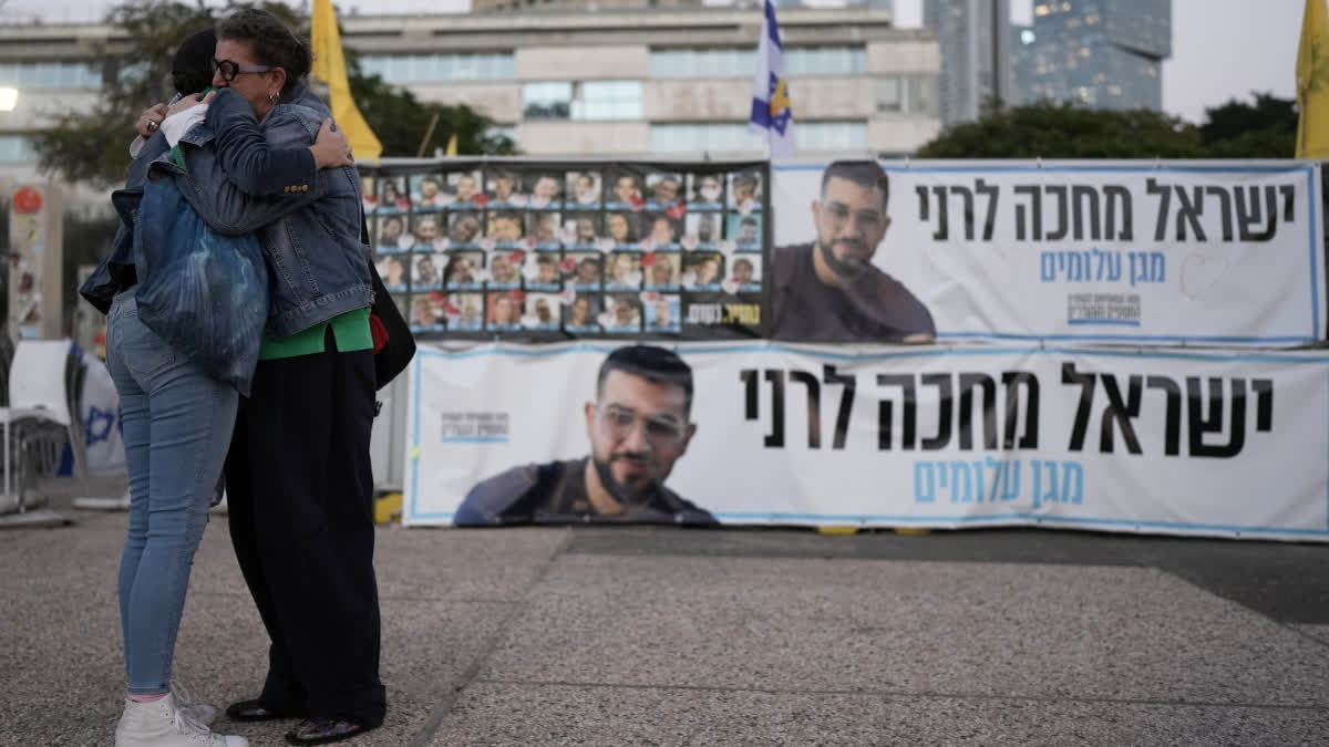 Netanyahu Says Israel Completed 'Moral Mission' With Return Of Final Gaza Hostage Ran Gvili Two women embrace next to a banner with a photo of Ran Gvili after the announcement that the hostage, whose remains were the last to be recovered from Gaza, had been identified, in a plaza known as Hostages Square in Tel Aviv, Israel, Monday, Jan. 26, 2026.