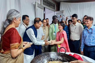 FILE- Union Finance Minister Nirmala Sitharaman and Minister of State for Finance Pankaj Chaudhary distribute halwa during the Halwa ceremony as the final stage of Budget preparations for the 'Lock-in' process commences, at North Block in New Delhi