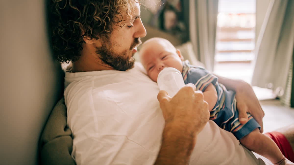 Father bottle feeding his baby