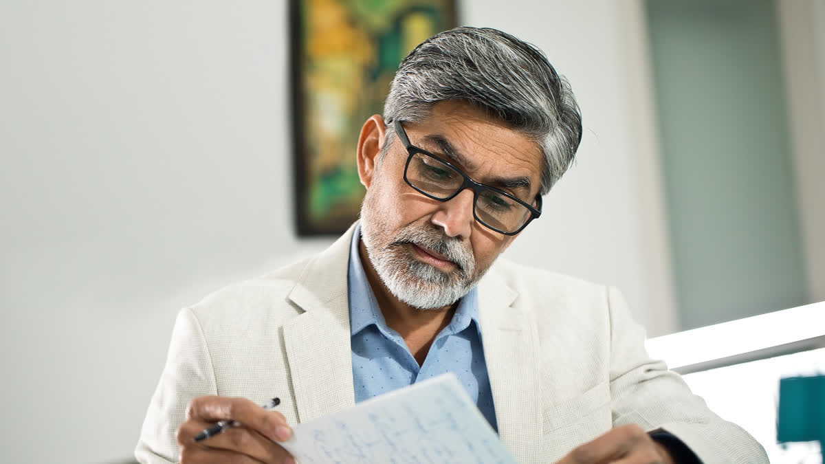 Man with glasses reading