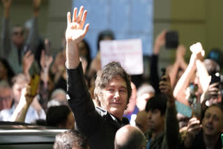 Argentina's President Javier Milei waves to supporters after voting during legislative midterm elections in Buenos Aires, Argentina, Sunday, Oct. 26, 2025.