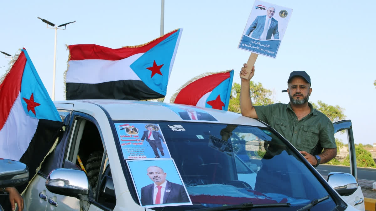 Supporters of the Southern Transitional Council (STC), a coalition of separatist groups seeking to restore the state of South Yemen, hold South Yemen flags and a poster of their leader, Aidarous al-Zubaidi during a rally, in Aden, Yemen, Dec. 25, 2025.