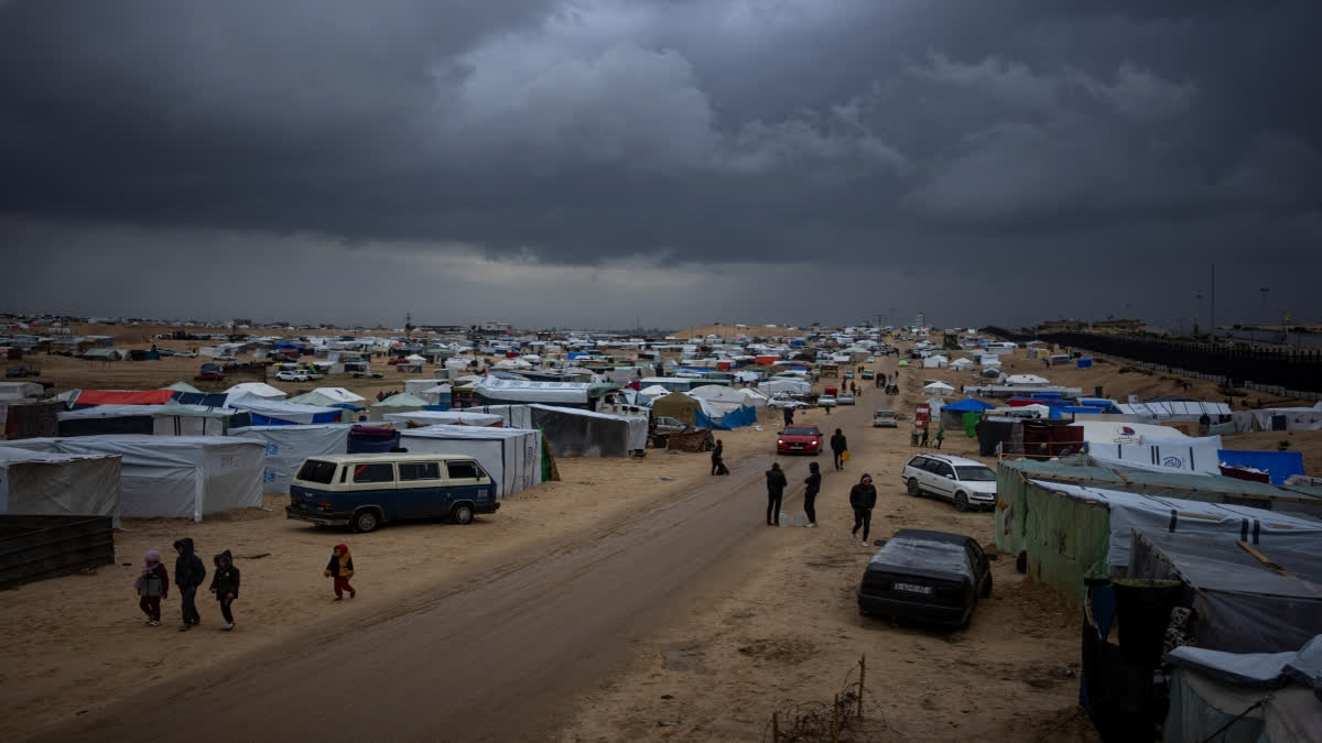 UN chief calls on countries to resume funding Gaza aid agency after allegations of militant ties Palestinians displaced by the Israeli air and ground offensive on the Gaza Strip walk through a makeshift tent camp in Rafah on Saturday, Jan. 27, 2024. (AP Photo/Fatima Shbair)
