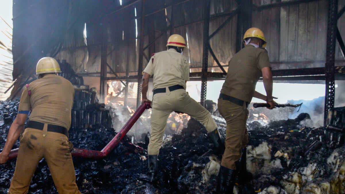 Firefighters try to douse the flames at the warehouse.
