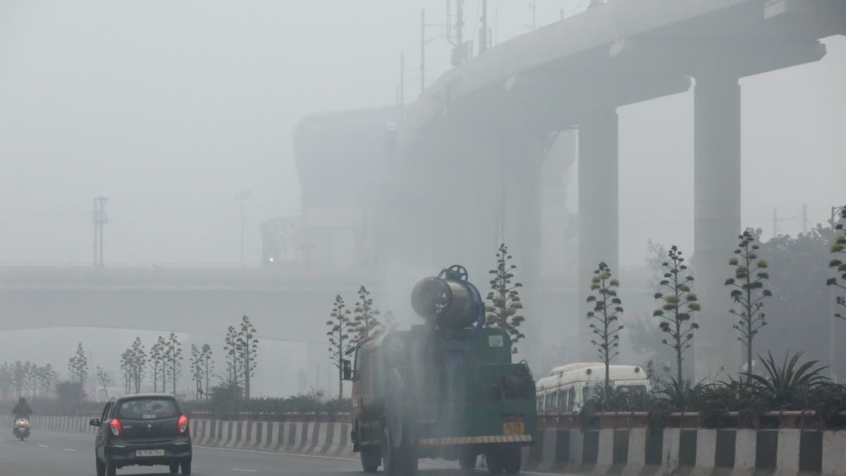 An anti-smog gun sprays water to curb pollution as air quality remains poor, in New Delhi.