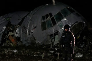 A military police stands next to a plane that crashed in El Alto, Bolivia, Friday, Feb. 27, 2026.