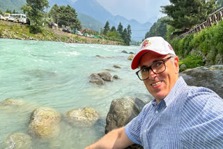 Jammu and Kashmir Chief Minister Omar Abdullah takes a selfie at a river bank during his visit, in Pahalgam on May 27.