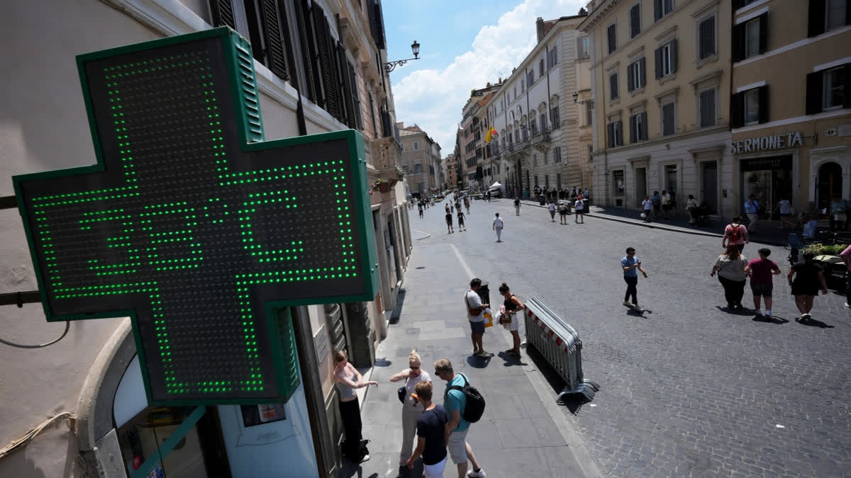 The thermometer of a drugstore shows the temperature of 38 degrees Celsius (100 degrees Fahrenheit) as temperatures reach record highs, in Rome.