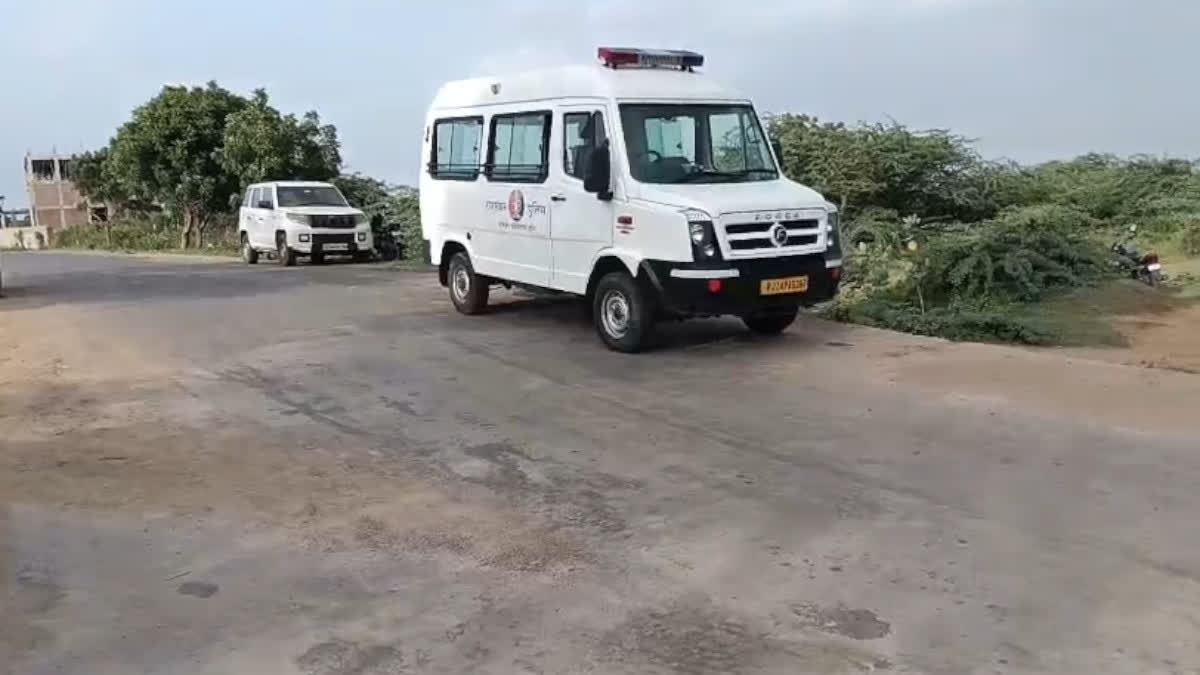 Police transporting the body in an ambulance