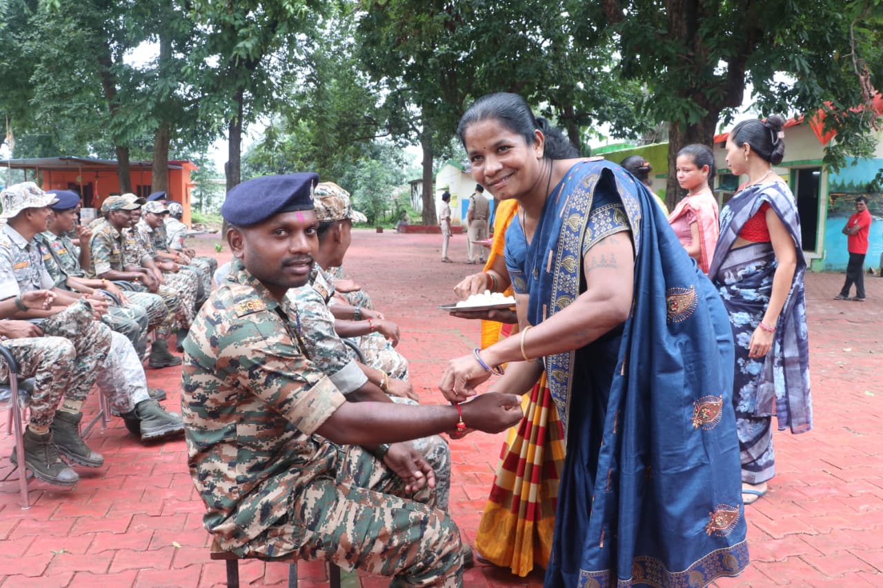 Surrendered female Naxalite feeding sweets to soldiers.