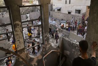 Palestinians survey the aftermath of an Israeli military strike on the Abu Dahrouj family home in Zawaida, central Gaza Strip, Thursday, Sept. 25, 2025.