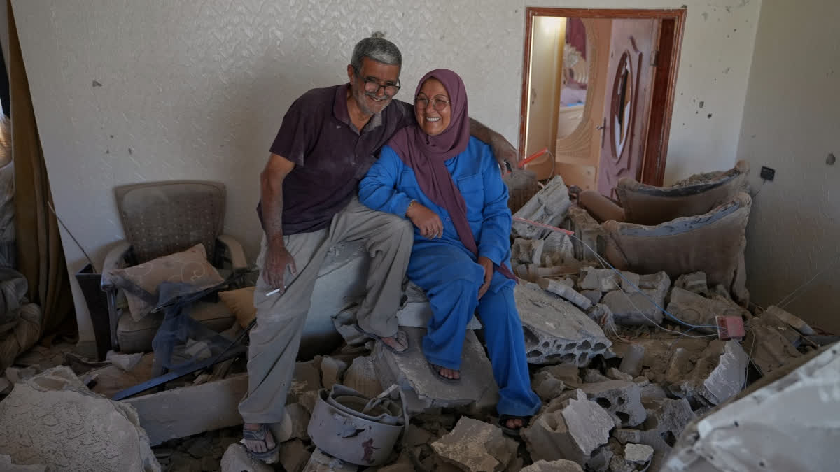 Mahasen Faqih and her husband, Mohammed Sobeih, smile as they sit amid the rubble of their home after returning to it following the Israeli military operation in Zawtar al-Gharbieh.