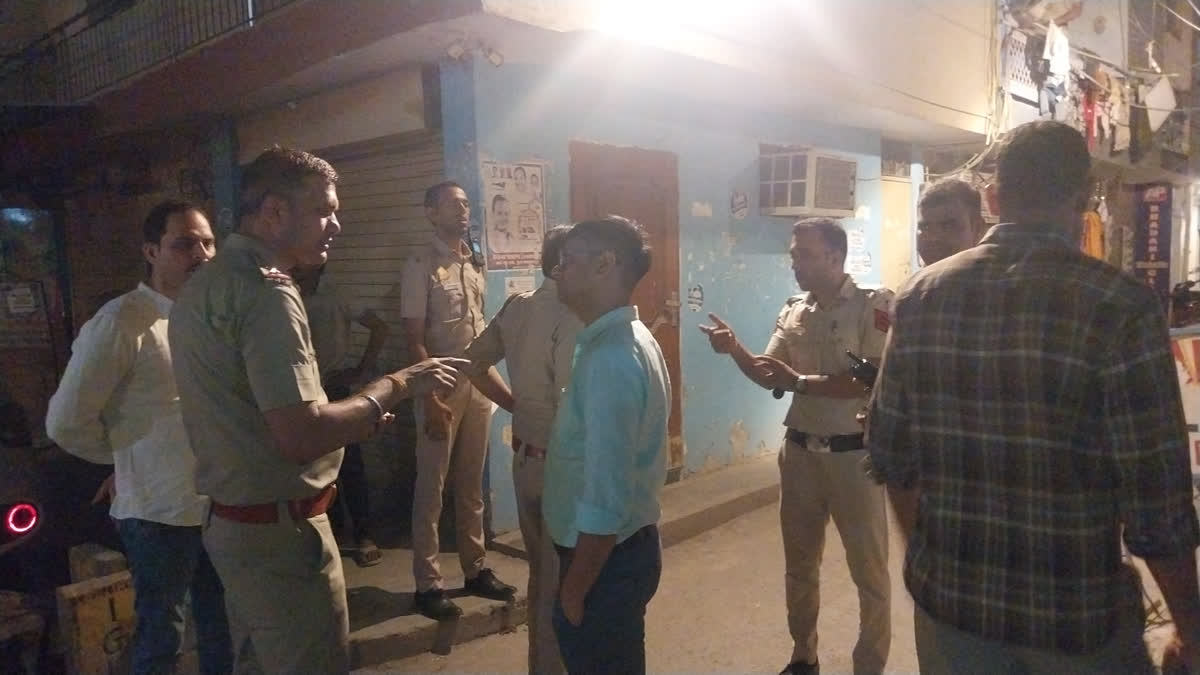 Police outside the house where a man allegedly bludgeoned his wife to death in South East Delhi