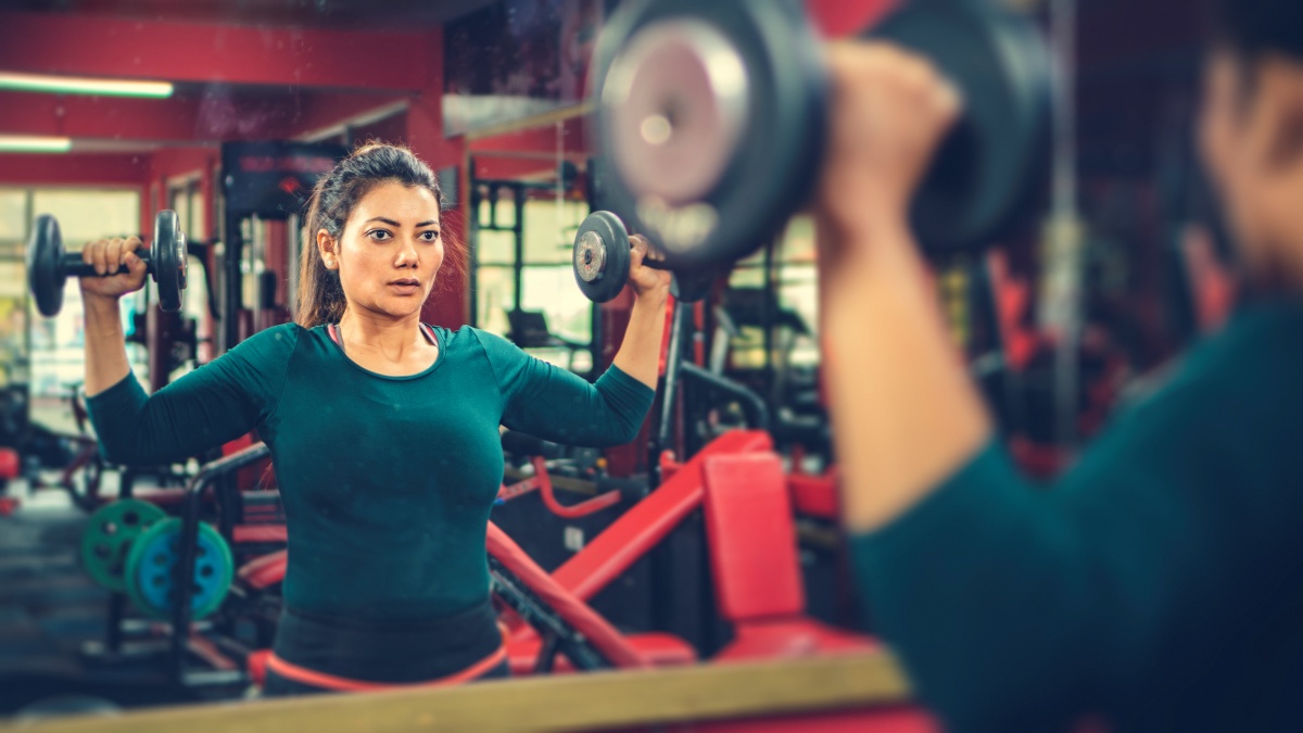 Woman lifting dumbbells in the gym