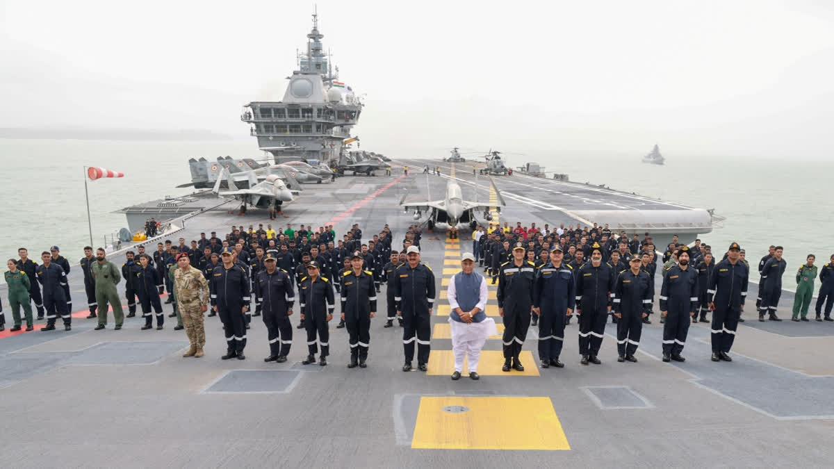 In this handout image released on May 30, 2025, Union Defence Minister Rajnath Singh with Chief of the Naval Staff (CNS) Admiral Dinesh K Tripathi and others aboard aircraft carrier INS Vikrant.