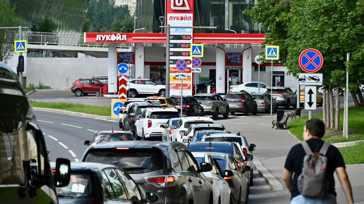 People queue to refuel their cars at a Lukoil petrol station in Moscow on June 30, 2026