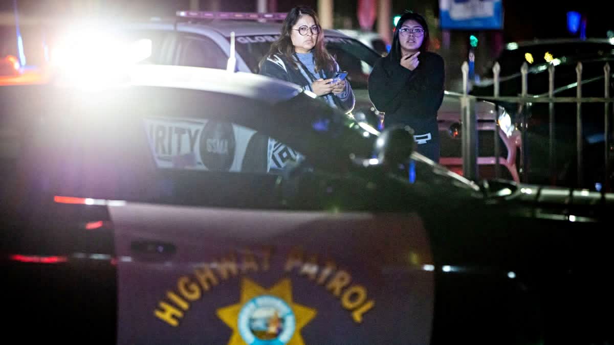 Bystanders watch at the scene of a mass shooting Saturday, Nov. 29, 2025, in Stockton, California