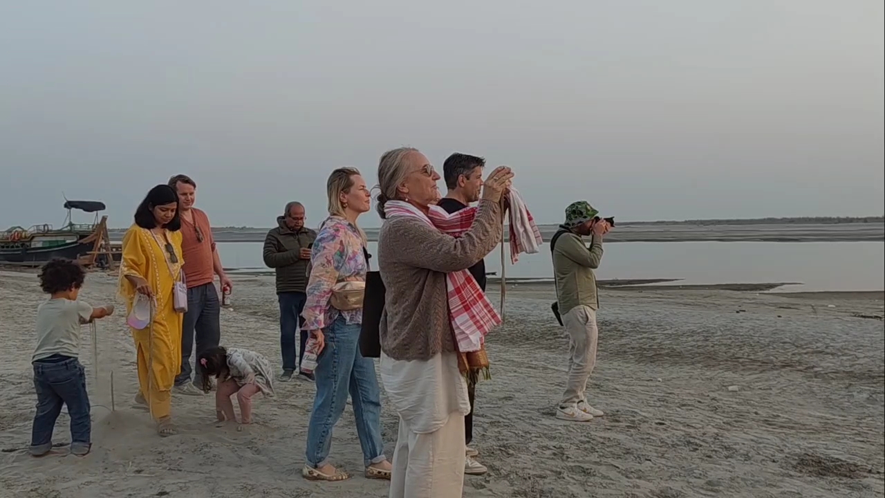 tourist mesmerized by the beauty of the sunset over the Brahmaputra