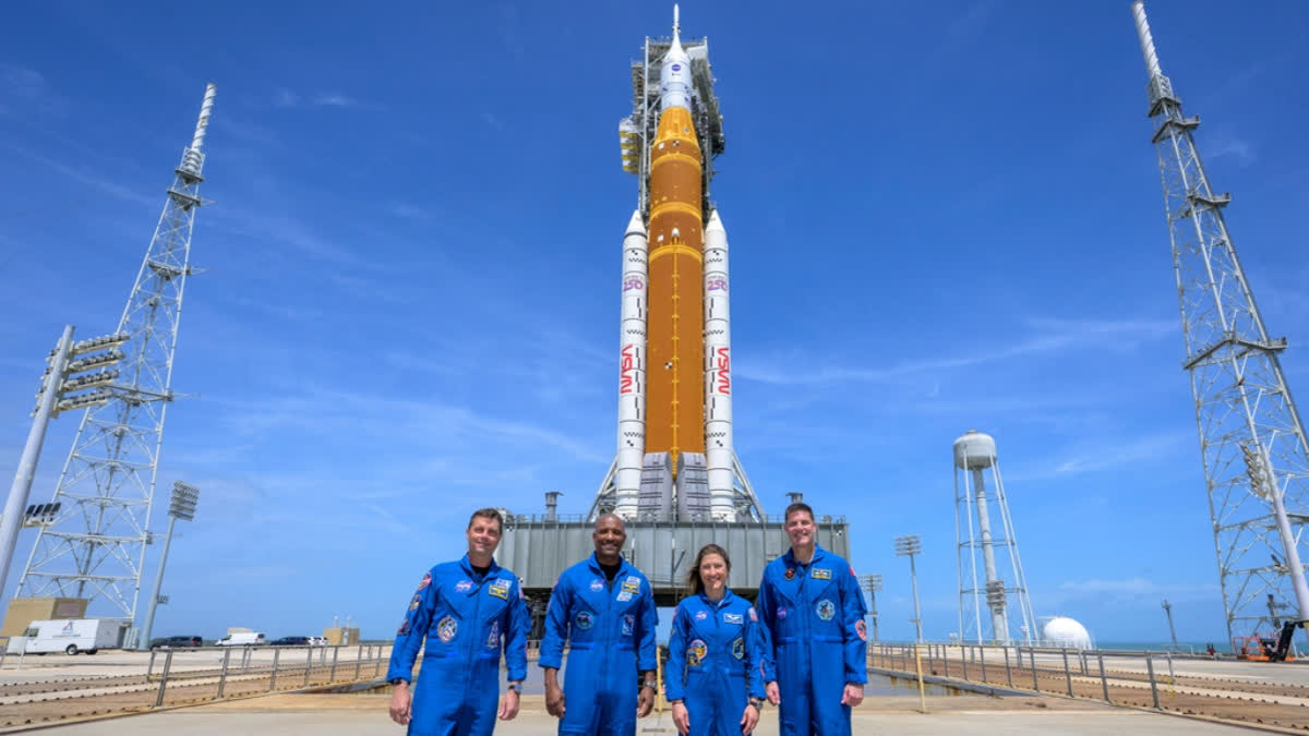 This photo provided by NASA shows NASA astronauts Reid Wiseman, Artemis II commander, from left, Victor Glover, Artemis II pilot, Christina Koch, Artemis II mission specialist, and CSA (Canadian Space Agency) astronaut Jeremy Hansen, Artemis II mission specialist, right, in a group photograph as they visit NASA's Artemis II SLS (Space Launch System) rocket and Orion spacecraft, Monday, March 30, 2026, at Launch Complex 39B of NASA's Kennedy Space Center, in Cape Canaveral, Fla.