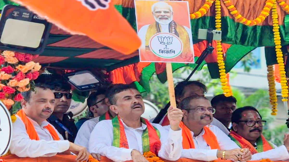 A file photo of Suvendu Ahikari on his way to file nominations for the assembly polls from Nandigram on Monday. Union Minister Dharmendra Pradhan is also seen.