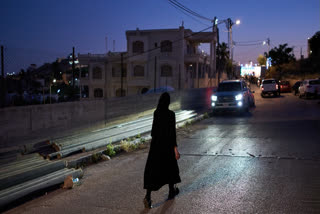 A Catholic nun walks on a street after taking part in a procession during the celebrations honoring the Virgin Mary in the West Bank town of Taybeh, Friday, May 29, 2026.