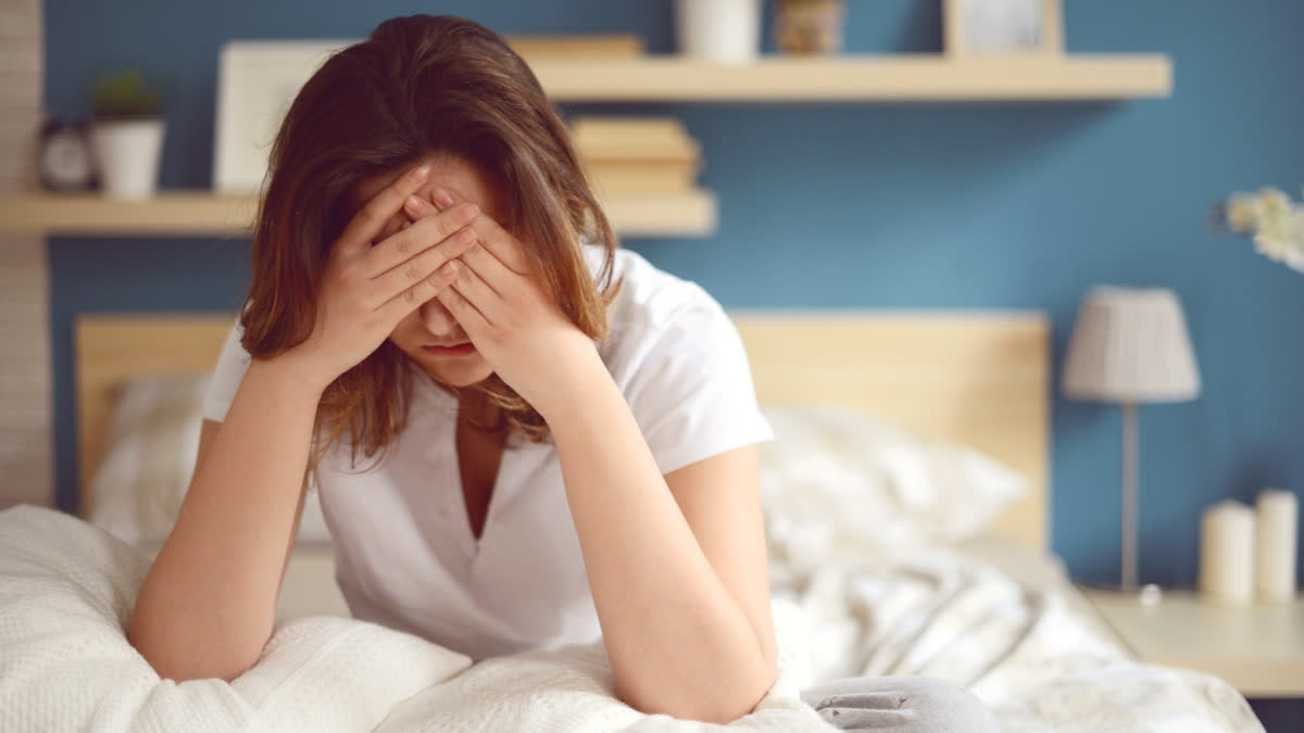 Girl looking depressed in bed