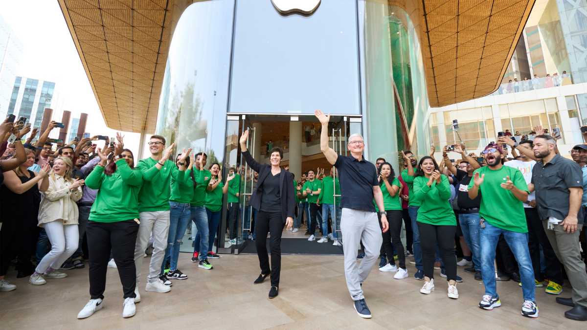 Deirdre O’Brien (Left) and Tim Cook (Right) cheer on the crowd of excited customers gathered outside Apple BKC in Mumbai in April 2023