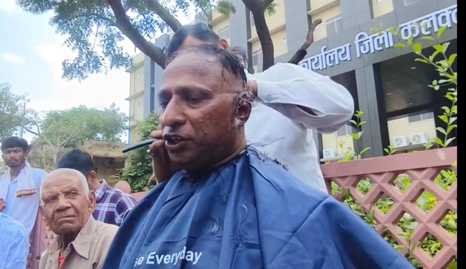 BJP worker Mahendra Bhati getting his head shaved in the Collectorate complex.